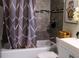 This bathroom features a tub with tile surround and decorative shower curtain at 548 Glen Haven Dr, Deltona, FL 32738
