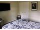 Comfortable bedroom with neutral tones, featuring a TV, closet, and cozy bedding at 548 Glen Haven Dr, Deltona, FL 32738