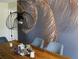 Contemporary dining space with unique light fixture, stylish wallpaper, and seating for four at 548 Glen Haven Dr, Deltona, FL 32738