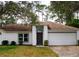 Inviting one-story home features a two-car garage, neutral paint, and covered front entryway at 548 Glen Haven Dr, Deltona, FL 32738