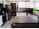 Spacious kitchen featuring stainless appliances, stone countertops, and an open layout for easy entertaining at 548 Glen Haven Dr, Deltona, FL 32738