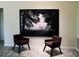 Minimalist interior featuring two chairs and large artwork, creating a serene and modern living space at 548 Glen Haven Dr, Deltona, FL 32738