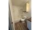 Bathroom featuring wood-look flooring, vanity, mirror, light fixture, toilet, and shower/tub combination at 5540 Devonbriar Way # 103, Orlando, FL 32822