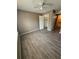 Bedroom featuring wood-look floors, neutral paint, closet, and a ceiling fan at 5540 Devonbriar Way # 103, Orlando, FL 32822