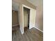 An open closet with shelving and a clothes bar is located in a room with wood-look floors at 5540 Devonbriar Way # 103, Orlando, FL 32822