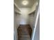 A walk-in closet features wood-look floors, hanging rods, and shelving for storage at 5540 Devonbriar Way # 103, Orlando, FL 32822