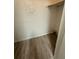 A closet with wood-look floors has a utility panel on the back wall and shelving above at 5540 Devonbriar Way # 103, Orlando, FL 32822