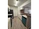 Well-lit kitchen featuring stainless steel appliances, a breakfast bar, and stylish fixtures at 5540 Devonbriar Way # 103, Orlando, FL 32822