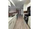 Bright kitchen open to the living area, featuring modern appliances and ample countertop space at 5540 Devonbriar Way # 103, Orlando, FL 32822
