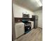 Modern kitchen with stainless steel appliances, clean lines, and contemporary finishes at 5540 Devonbriar Way # 103, Orlando, FL 32822