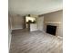 Open-concept living room featuring a fireplace, seamlessly connecting to the kitchen area at 5540 Devonbriar Way # 103, Orlando, FL 32822