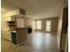 Bright living space with a fireplace, adjacent to the kitchen with a convenient breakfast bar at 5540 Devonbriar Way # 103, Orlando, FL 32822