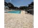 Community pool surrounded by lounge chairs at 5540 Devonbriar Way # 103, Orlando, FL 32822