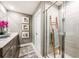 Contemporary bathroom featuring double sinks, a tiled shower with a wooden ladder, and stylish decor creating a spa-like feel at 560 Southern Edge Way, Sanford, FL 32771