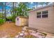 The backyard features a shed and concrete walkway amid natural foliage at 607 W Club Blvd, Lake Mary, FL 32746