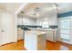 Bright kitchen with white cabinets, modern appliances, an island, and a pantry at 607 W Club Blvd, Lake Mary, FL 32746