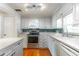 Bright kitchen with white cabinets, modern appliances, and hardwood floors at 607 W Club Blvd, Lake Mary, FL 32746