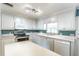 Bright kitchen with white cabinets, modern appliances, and a functional island at 607 W Club Blvd, Lake Mary, FL 32746