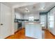 Bright kitchen with white cabinets, modern appliances, island, and hardwood floors at 607 W Club Blvd, Lake Mary, FL 32746