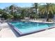 Relaxing community pool featuring lounge chairs, lush landscaping and palm trees at 607 W Club Blvd, Lake Mary, FL 32746