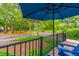 Cozy front porch with a patio umbrella and views of the community landscaping at 607 W Club Blvd, Lake Mary, FL 32746