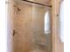 A walk in shower with glass door, stone-look tiles, and a seat at 607 W Club Blvd, Lake Mary, FL 32746