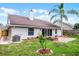 View of the rear exterior features a brick patio and green grassy area at 635 Holbrook Cir, Lake Mary, FL 32746