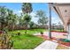 Lovely backyard features a lush green lawn, brick patio, and privacy fence at 635 Holbrook Cir, Lake Mary, FL 32746