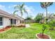 Spacious backyard with lush green grass, brick patio, mature trees, and privacy fence at 635 Holbrook Cir, Lake Mary, FL 32746