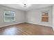 Sunlit bedroom with dual windows, providing ample natural light and wood flooring at 635 Holbrook Cir, Lake Mary, FL 32746