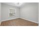 Bedroom features hardwood flooring and natural light from a large window at 635 Holbrook Cir, Lake Mary, FL 32746