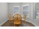 Cozy breakfast nook with natural light and a round wooden table with four chairs at 635 Holbrook Cir, Lake Mary, FL 32746