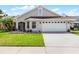 Charming single-story home featuring a well-maintained lawn and a two-car garage, under a sunny sky at 635 Holbrook Cir, Lake Mary, FL 32746