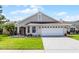 Charming single-story home featuring a well-maintained lawn and a two-car garage, under a sunny sky at 635 Holbrook Cir, Lake Mary, FL 32746