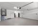 Spacious garage with white walls, ample storage, and overhead lighting perfect for a workshop or parking at 635 Holbrook Cir, Lake Mary, FL 32746
