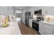 Modern kitchen with white cabinetry, stainless steel appliances, and hardwood floors at 635 Holbrook Cir, Lake Mary, FL 32746