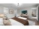 The primary bedroom is staged with warm colors, a seating area, and a view into the primary bathroom at 635 Holbrook Cir, Lake Mary, FL 32746
