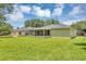 Back exterior view highlighting the screened porch, spacious yard, and home's architectural details at 638 Sun Bluff Ln, Apopka, FL 32712