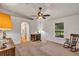 Spacious bedroom features a ceiling fan, desk, rocking chair, and an archway to an attached room at 638 Sun Bluff Ln, Apopka, FL 32712