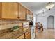 Functional kitchen featuring granite countertops, wood cabinets, and white appliances for a classic look at 638 Sun Bluff Ln, Apopka, FL 32712