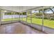 Inviting screened porch with tile flooring, providing a relaxing outdoor living space overlooking the yard at 638 Sun Bluff Ln, Apopka, FL 32712
