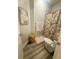 Charming bathroom with a shower featuring a patterned curtain and stylish decor at 6686 Treymont Dr, Lakeland, FL 33813