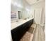 Bathroom with double sinks, vanity, and neutral color scheme at 6686 Treymont Dr, Lakeland, FL 33813