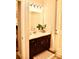 Well-lit powder room with modern vanity, bright mirror, and elegant finishes at 6686 Treymont Dr, Lakeland, FL 33813