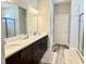 Elegant bathroom with double vanity, quartz countertop, and a glass-enclosed shower at 6686 Treymont Dr, Lakeland, FL 33813
