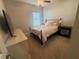 Cozy bedroom with carpet, ceiling fan, and a window offering natural light at 6686 Treymont Dr, Lakeland, FL 33813