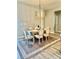 Cozy dining area with elegant lighting and a well-placed table, adjacent to the modern kitchen at 6686 Treymont Dr, Lakeland, FL 33813