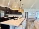Stylish kitchen featuring a large quartz island, stainless steel appliances, and dark cabinetry at 6686 Treymont Dr, Lakeland, FL 33813