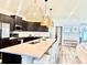 Modern kitchen features an island with seating, stainless steel appliances, and stylish pendant lighting at 6686 Treymont Dr, Lakeland, FL 33813