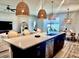 Modern kitchen boasts an island with quartz countertops and stylish pendant lighting at 6686 Treymont Dr, Lakeland, FL 33813